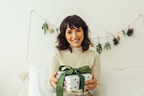 Smiling woman with a christmas  present