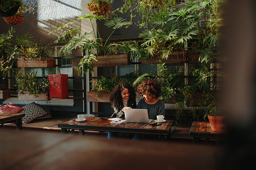 Women discussing ideas over coffee