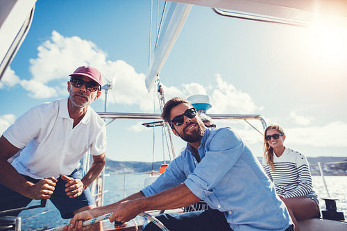 Men pulling rope on deck of a boat