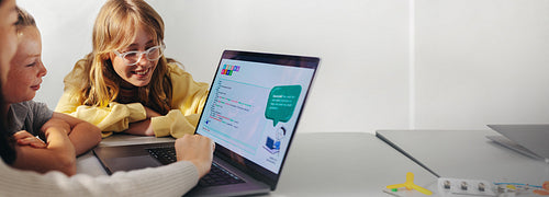 The coding classmates: Group of elementary school children learning how to code togethe