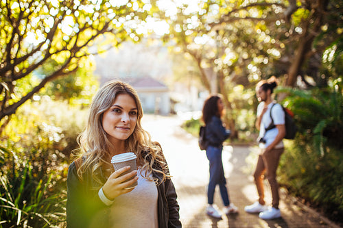 Woman in park holding a coffee glass