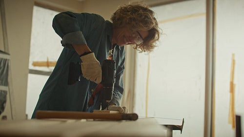 Woman using power drill during home renovation project