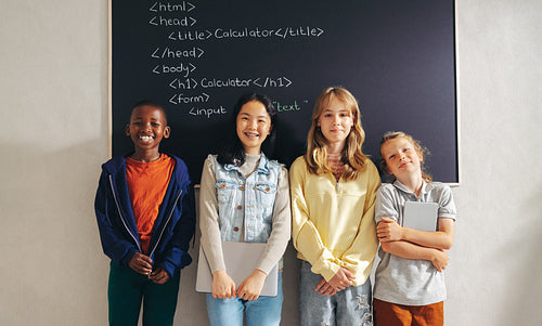 Innovative minds: group of kids standing in a computer coding class