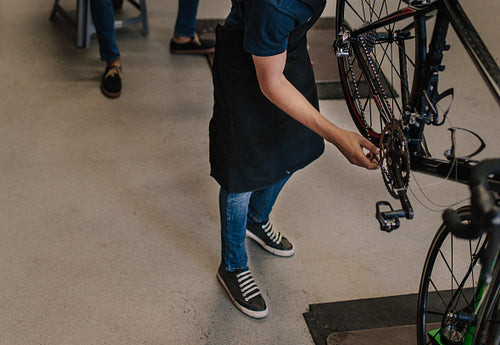 Mechanic repairing a bicycle in workshop