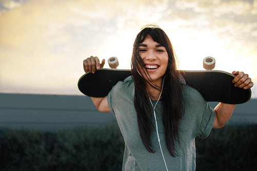 Woman with skateboard outdoors