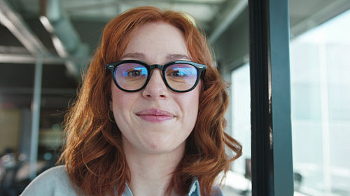 Female professional smiling at the camera in an office