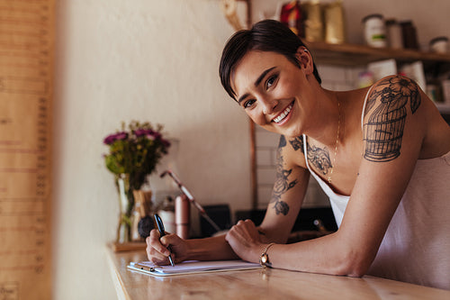 Woman entrepreneur standing at the counter of her cafe