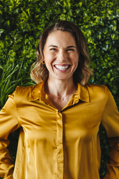 Portrait of a happy female entrepreneur working in a sustainable workplace