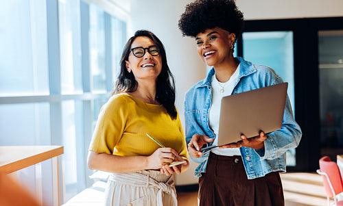 Shaping new ideas: Colleagues refine plans during a quick huddle