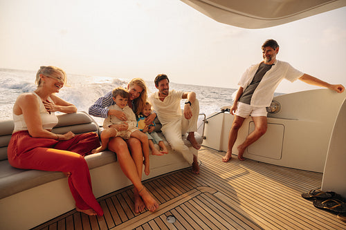 Cheerful family relishing a motorboat excursion at sunset on the open water