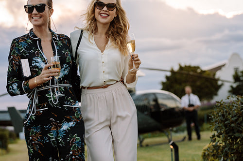 Glamorous women walking with wine