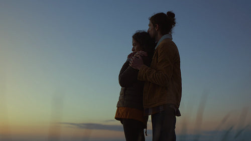 Couple in love admiring the seascape in evening