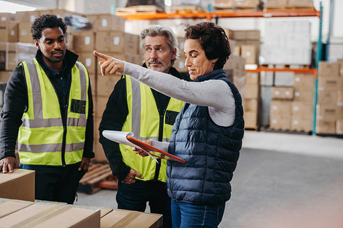 Female warehouse manager discussing with her team during a meeting