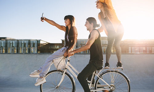 Friends on bike posing for a selfie