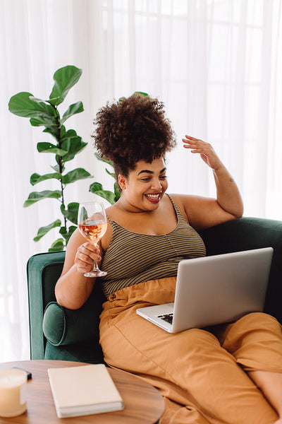 Woman video chatting on laptop at home