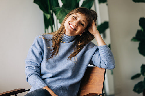 Cheerful young businesswoman smiling at the camera in an office