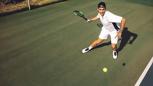 Young man in sportswear practicing tennis