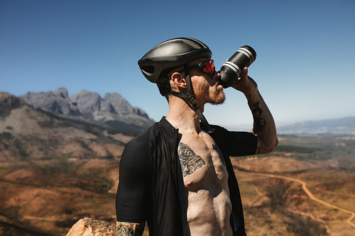 Cyclist drinking water from bottle