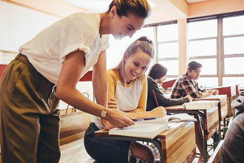 Teacher assisting a student in the classroom