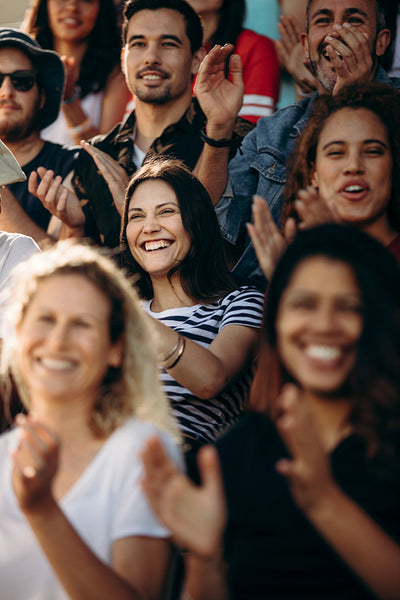 Crowd of sports fans cheering during a match