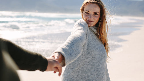Couple enjoying a walking on beach