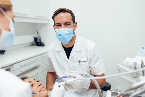 Successful dentist working on patient's teeth