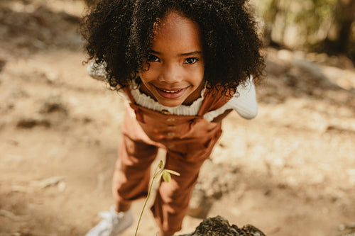 Girl with a wild flower in forest