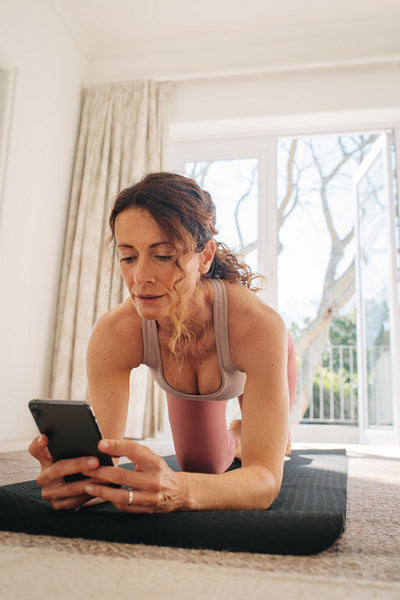 Woman using fitness app to workout
