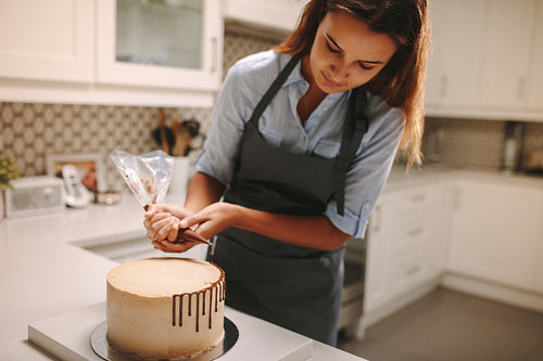 Confectioner decorates a cake