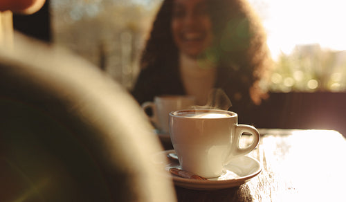 Steaming hot coffee at a coffee shop