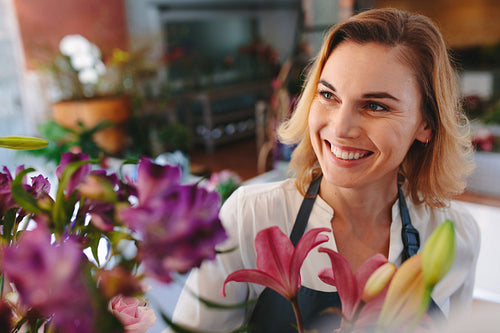 Happy female florist at flower shop