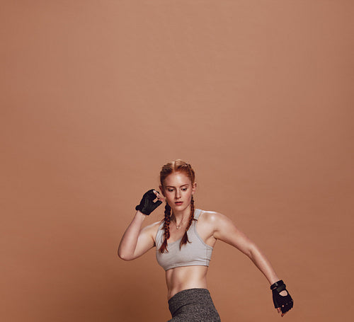 Muscular young woman athlete exercising