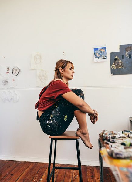 Female artist sitting in her workshop