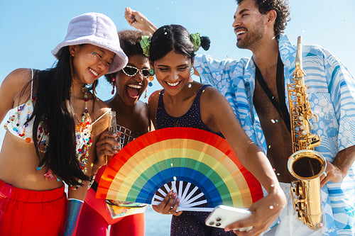 Friends celebrate brazilian carnaval on the beach