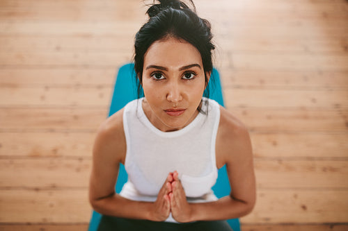 Fitness woman practising yoga at home
