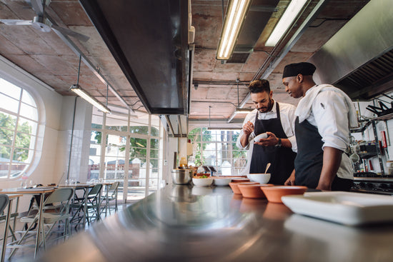 Gourmet chef cooking in a commercial kitchen – Jacob Lund Photography  Store- premium stock photo