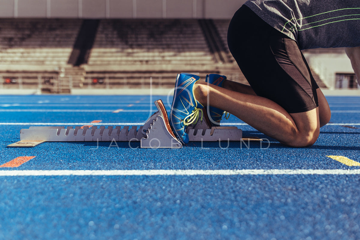 Female sprinter taking off from starting block on a running track – Jacob  Lund Photography Store- premium stock photo