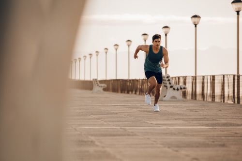 Happy young man drinking water after workout outdoors stock photo (124775)  - YouWorkForThem