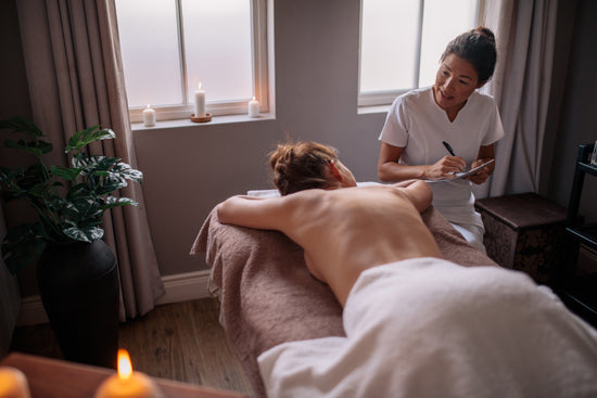 Woman getting back massage at spa resort – Jacob Lund Photography