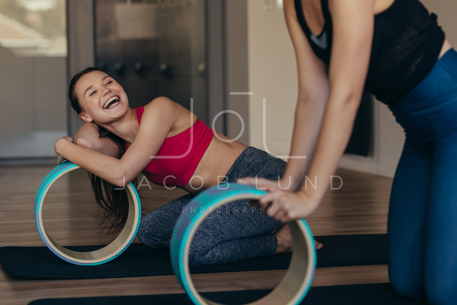 Pilates women at a gym holding a yoga or pilates wheel – Jacob