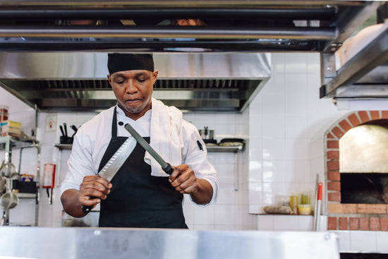 Gourmet chef cooking in a commercial kitchen – Jacob Lund Photography  Store- premium stock photo