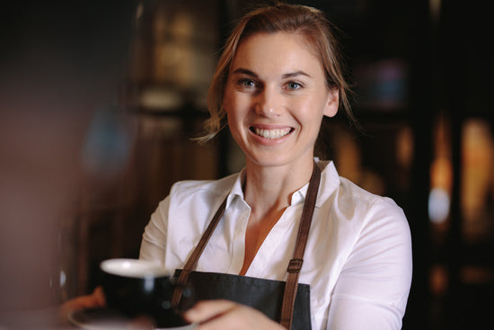 Smiling barista making espresso with a coffee maker – Jacob Lund  Photography Store- premium stock photo