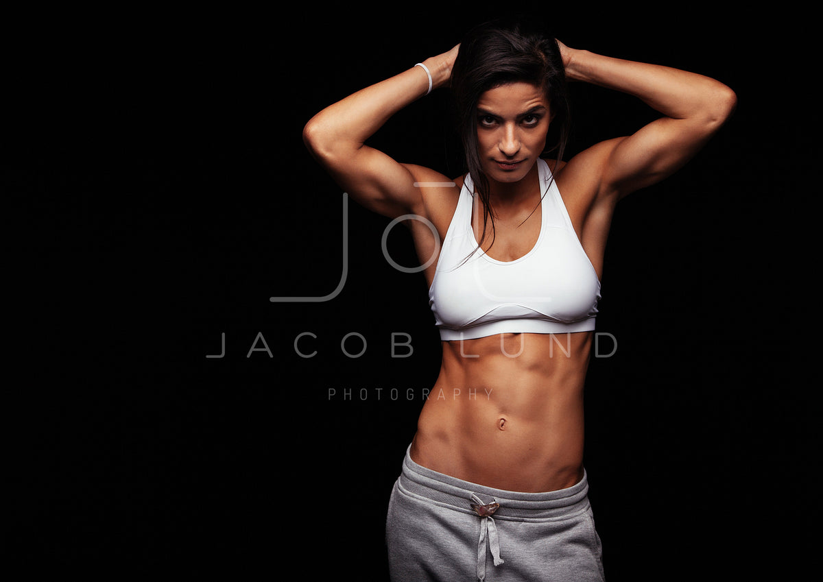 Muscular woman posing in fitness clothing – Jacob Lund Photography Store- premium  stock photo