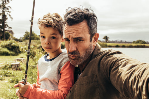 Happy man and kid fishing in a lake – Jacob Lund Photography Store