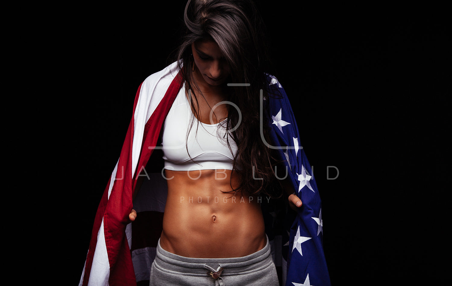 Female athlete carrying an American flag – Jacob Lund Photography