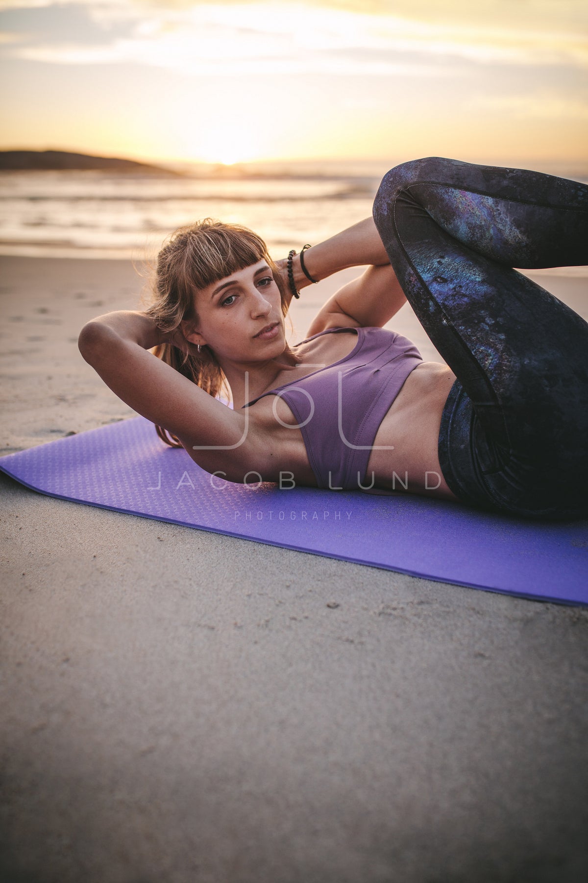 Young woman practicing yoga at beach – Jacob Lund Photography Store-  premium stock photo