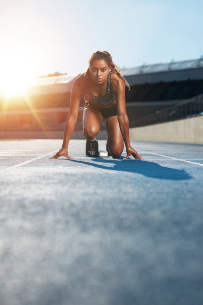 Female runner standing on race track – Jacob Lund Photography Store-  premium stock photo