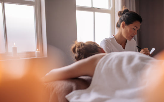 Woman getting back massage at spa resort – Jacob Lund Photography