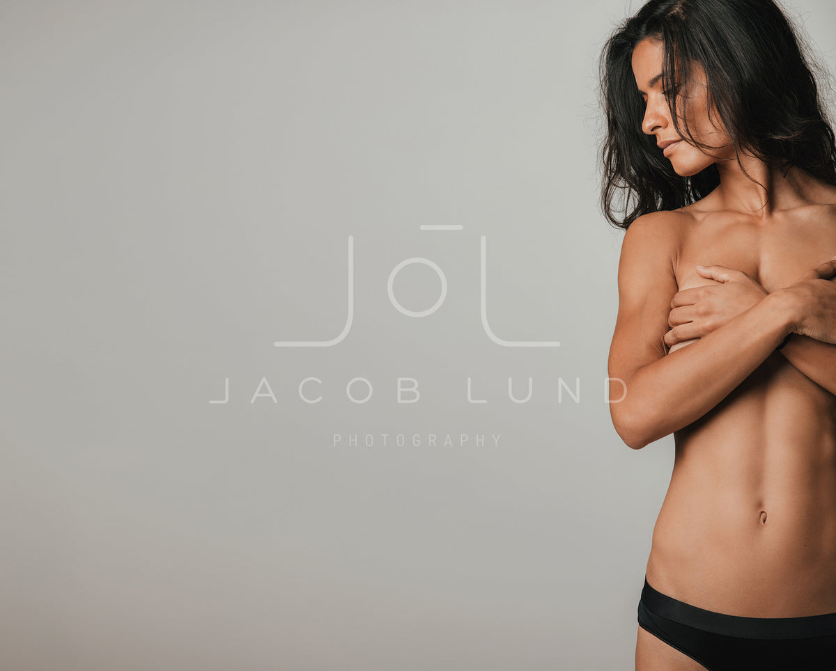 Fit partially nude woman looking sideways – Jacob Lund Photography Store-  premium stock photo