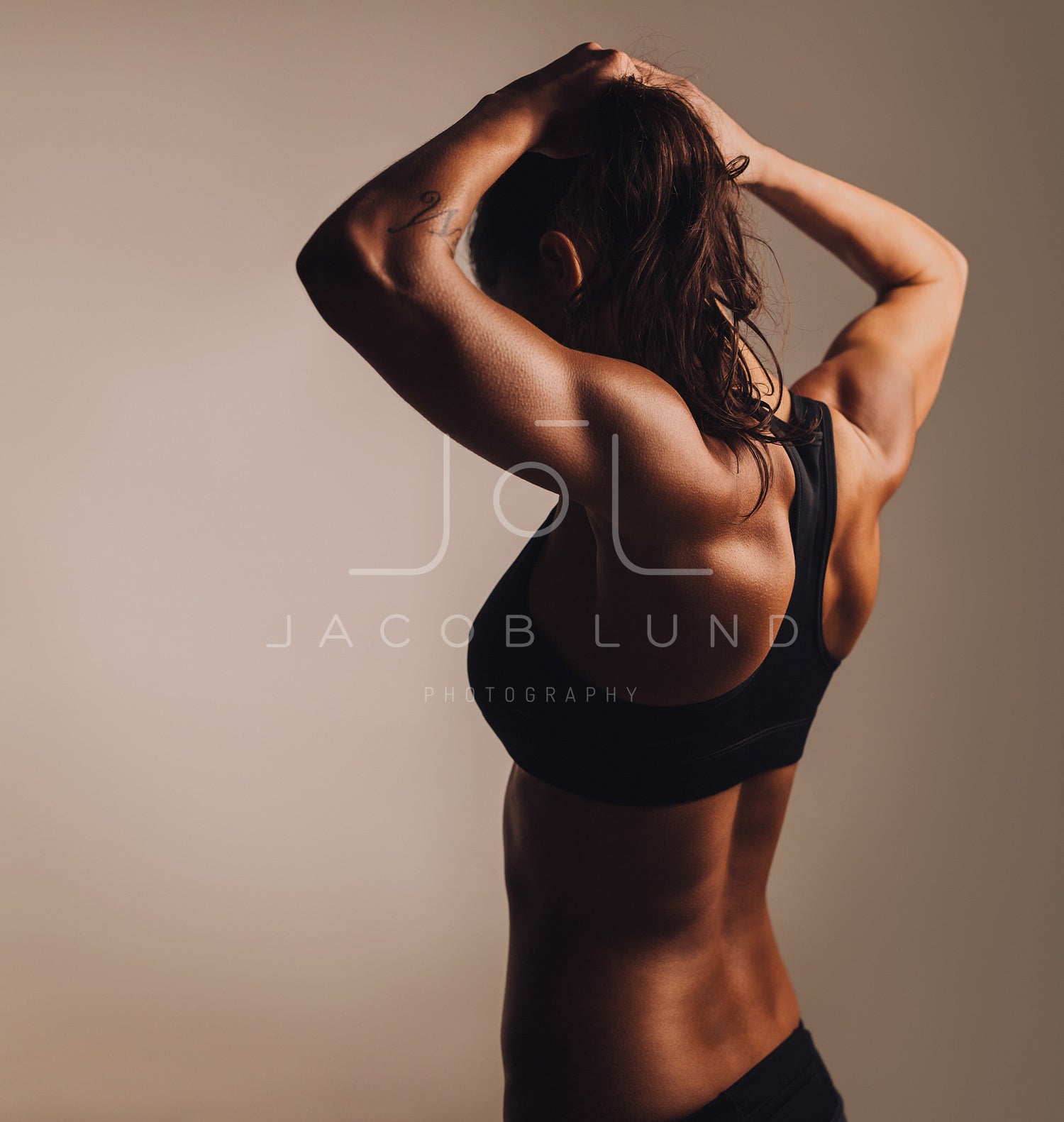 Fitness female showing muscular back